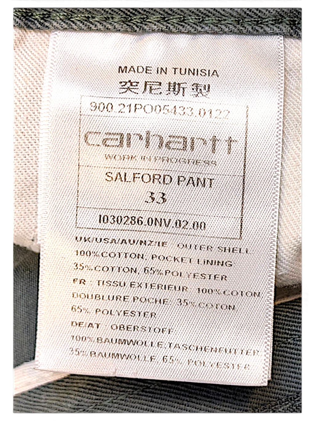 JAKE & IPI Carhartt Salford work pants internal care label showing size 33 and cotton material composition