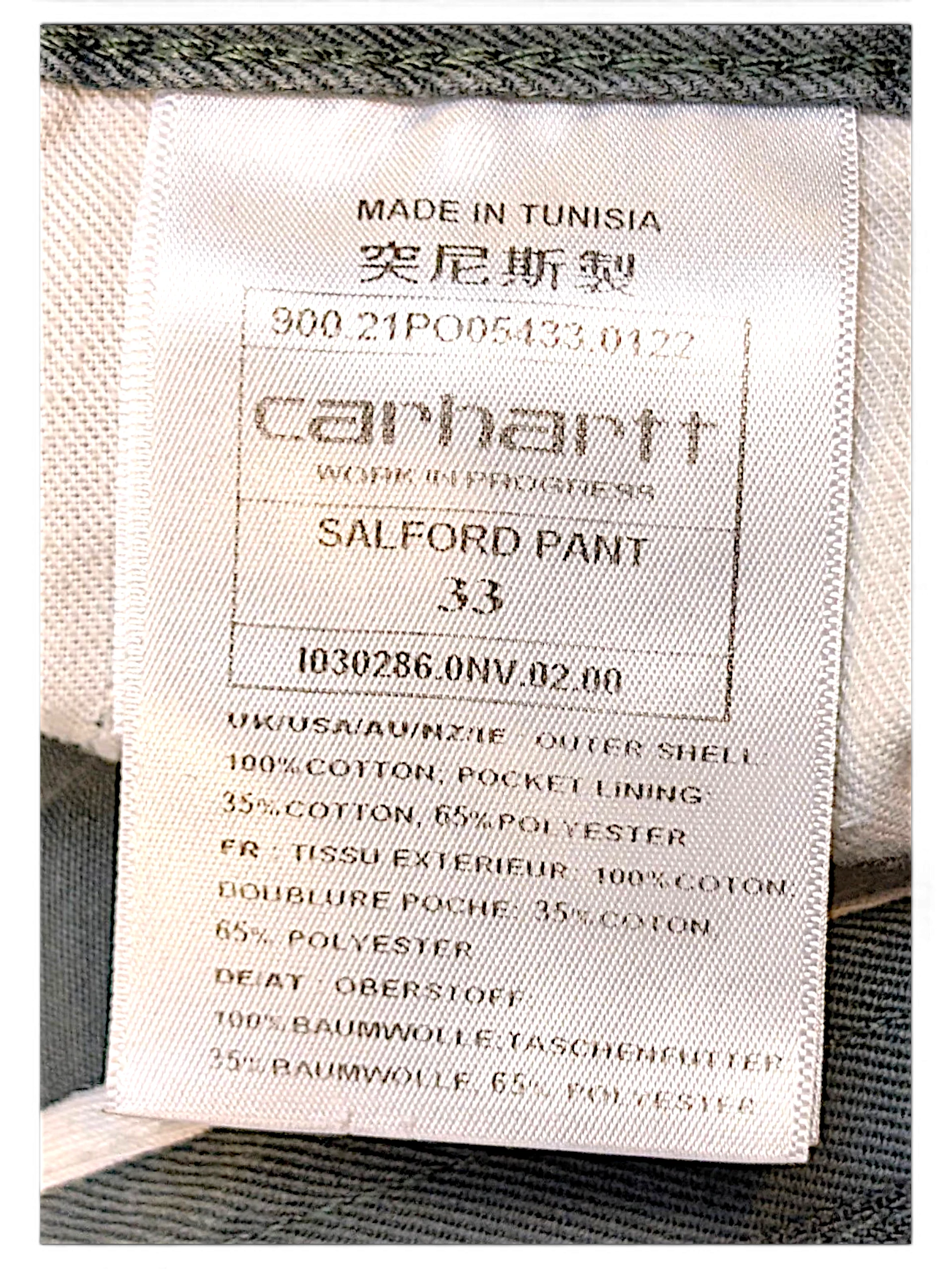 JAKE & IPI Carhartt Salford work pants internal care label showing size 33 and cotton material composition