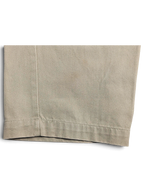 Close-up of the beige cotton fabric and hem detail on JAKE & IPI Cedarwood State straight leg chinos.