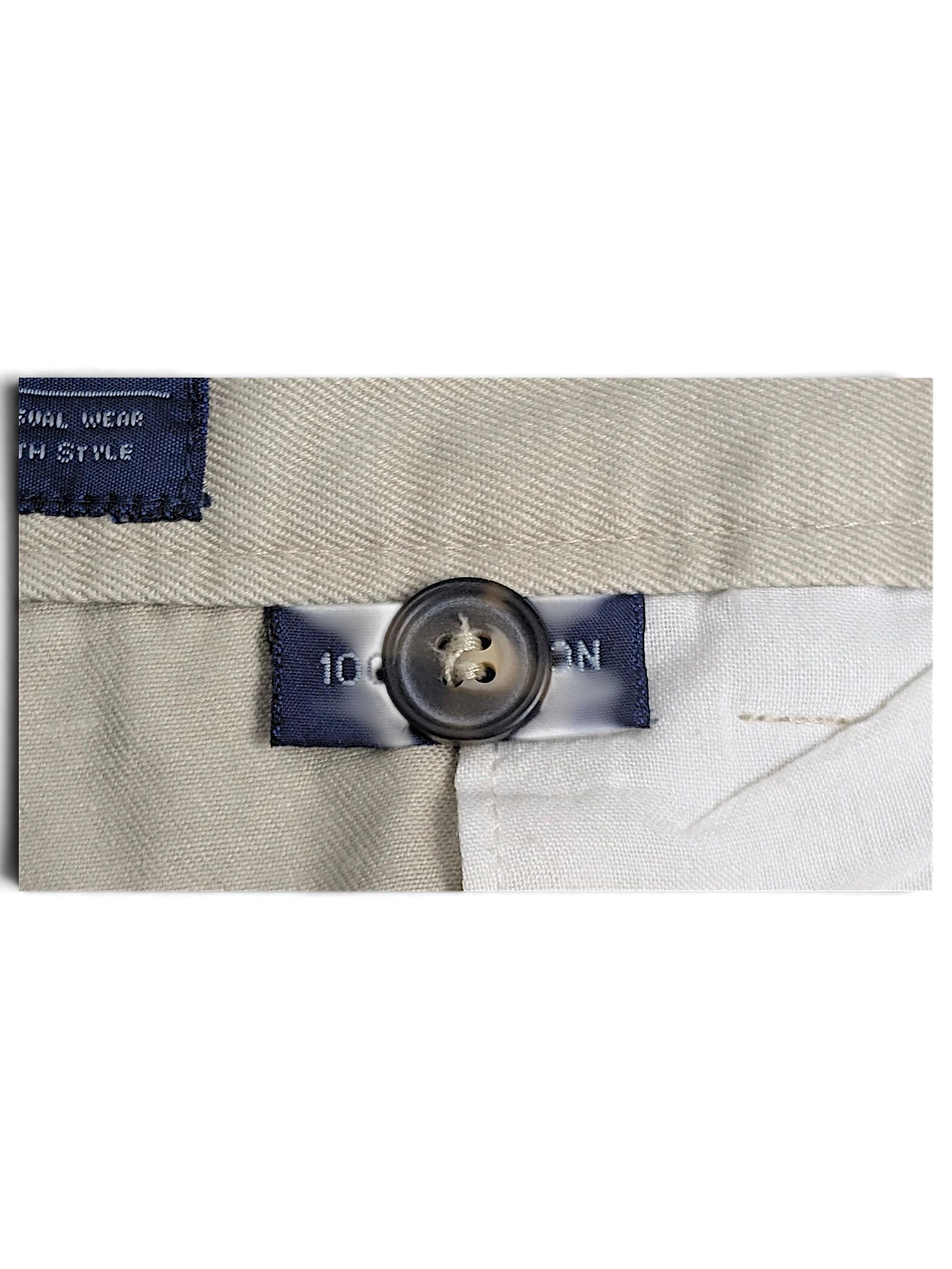JAKE & IPI Cedarwood State beige cotton trousers detail showing the button and fabric composition label