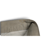 Close-up of the beige cotton fabric and waistband construction of JAKE & IPI Cedarwood State pleated trousers.
