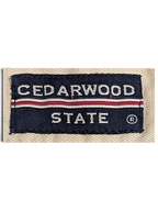JAKE & IPI Cedarwood State navy blue and red woven brand label on beige cotton fabric