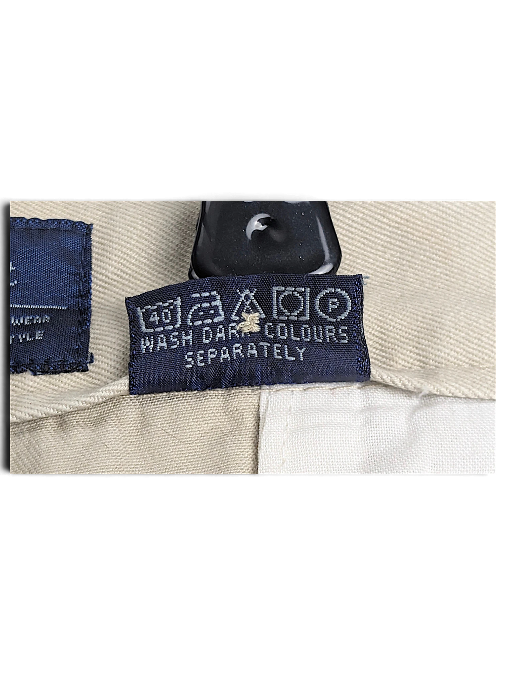 JAKE & IPI Cedarwood State beige trousers care label with washing instructions and symbols