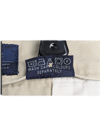 JAKE & IPI Cedarwood State beige trousers care label with washing instructions and symbols