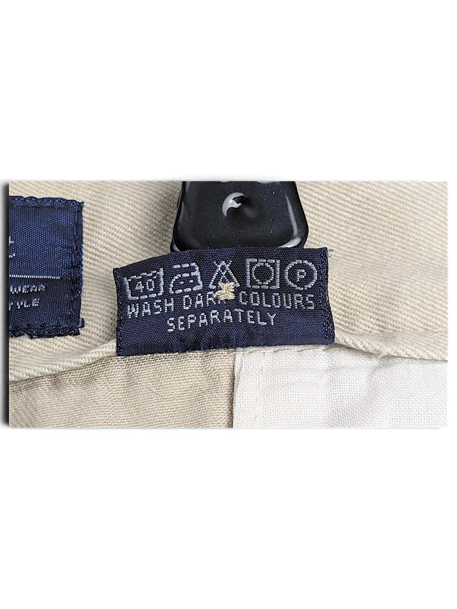JAKE & IPI Cedarwood State beige trousers care label with washing instructions and symbols