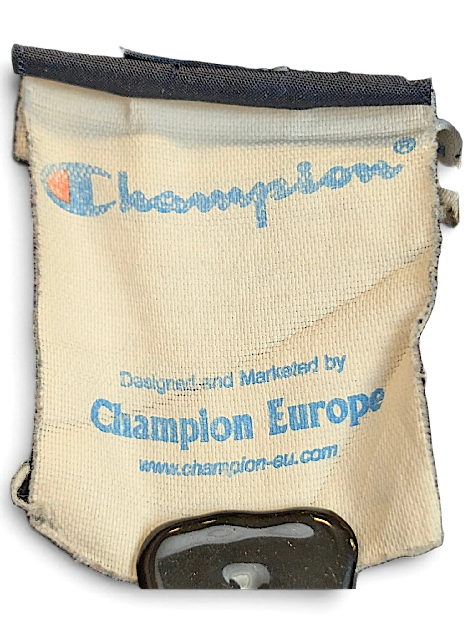 JAKE & IPI Champion Europe brand label tag from navy track pants showing logo and website details