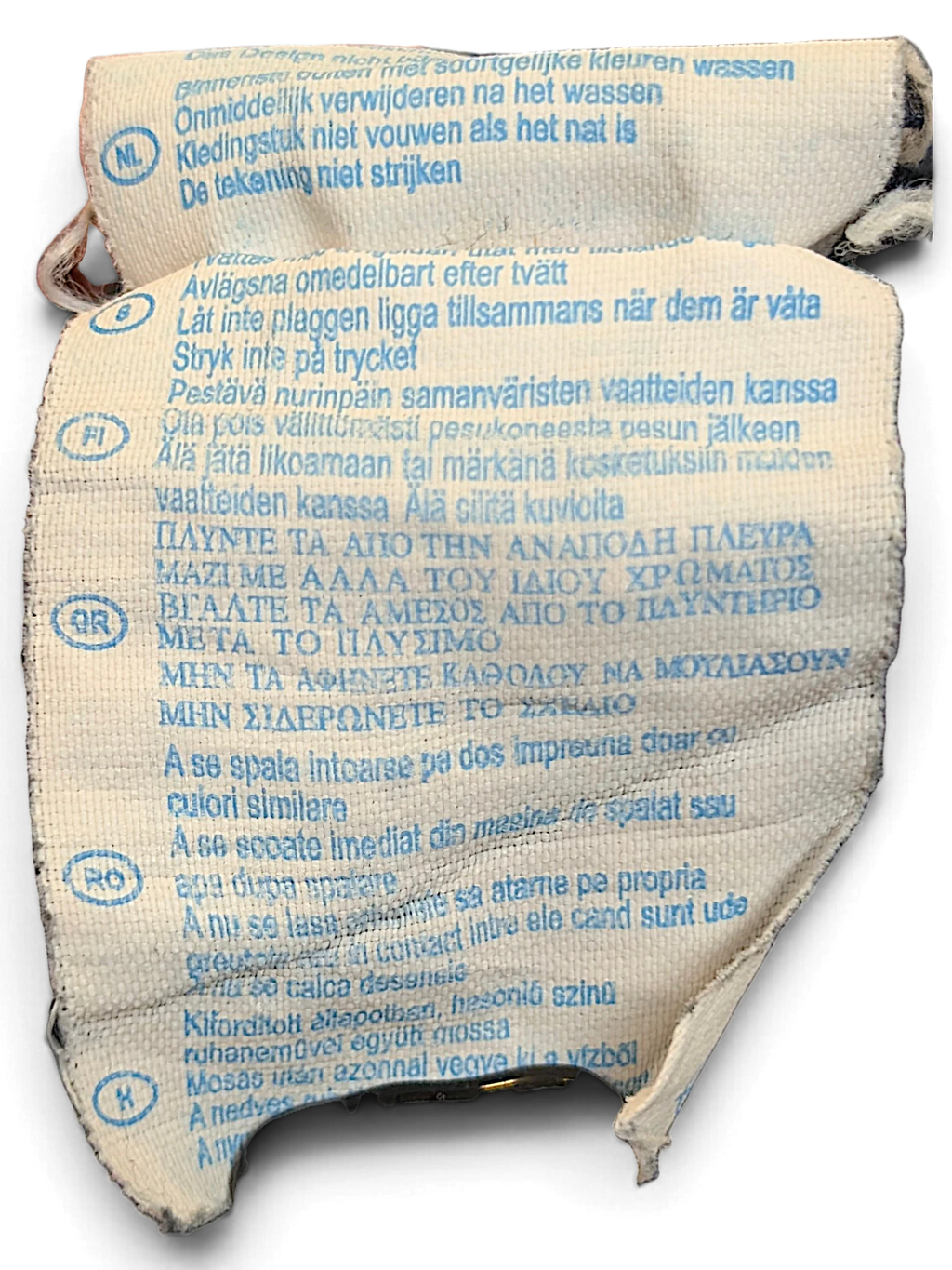 JAKE & IPI Champion track pants care label with multi-language washing instructions on a white fabric tag