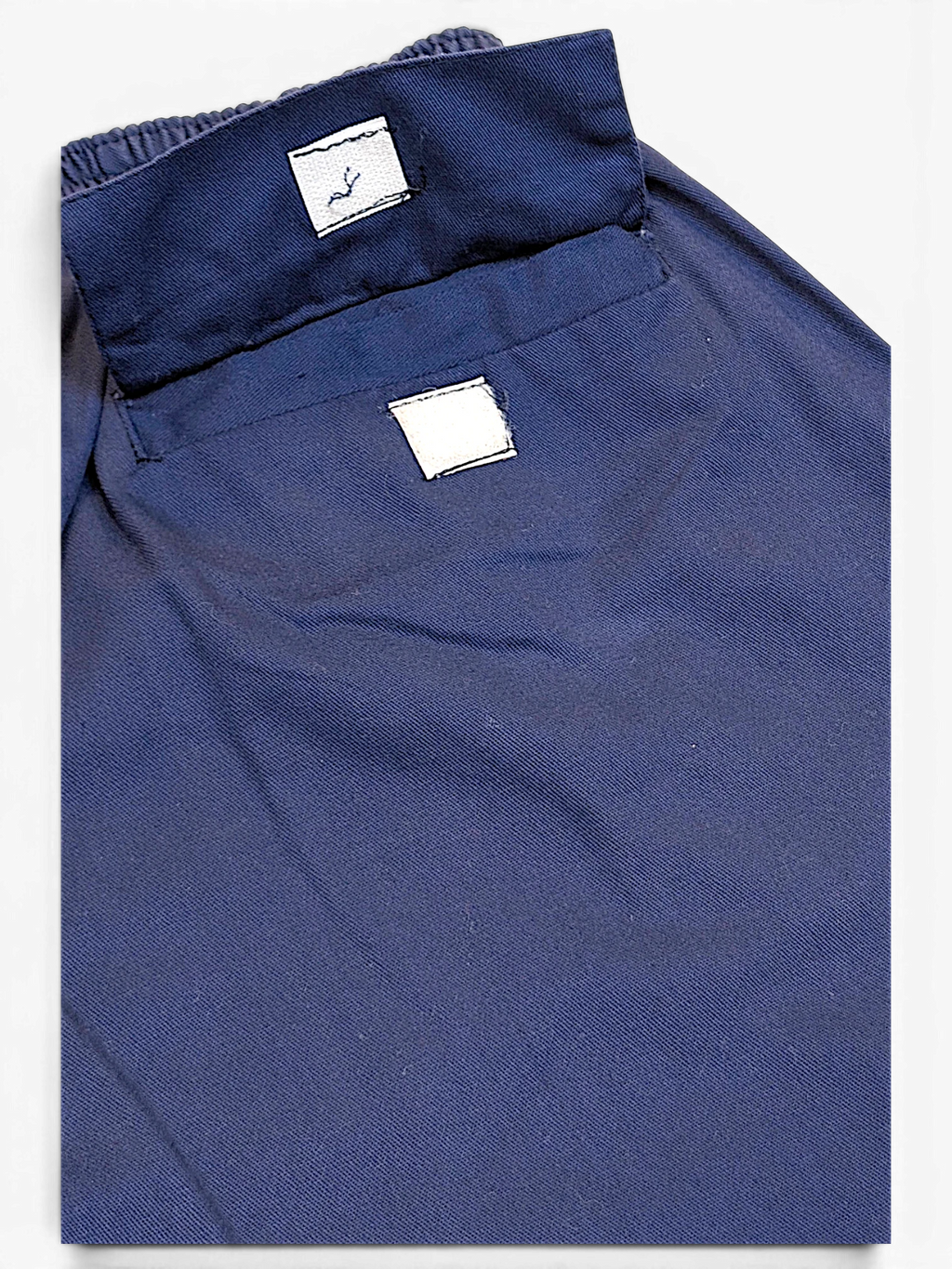 JAKE & IPI Champion faded blue track pants featuring a relaxed fit and visible pre-owned wear