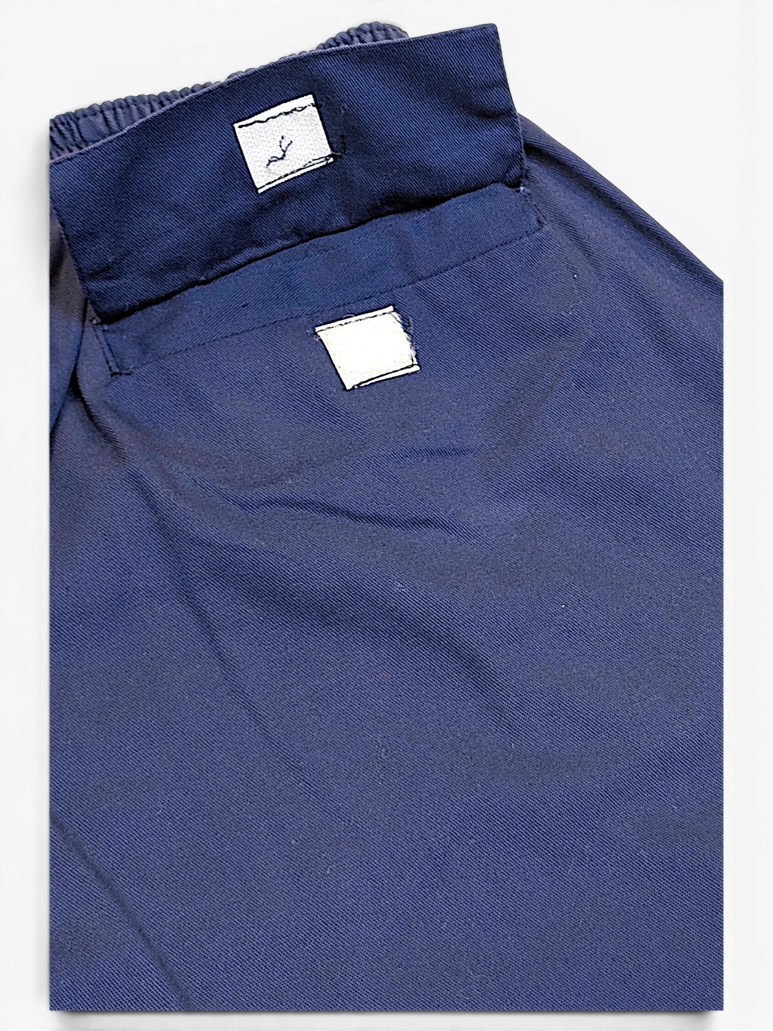 JAKE & IPI Champion faded blue track pants featuring a relaxed fit and visible pre-owned wear