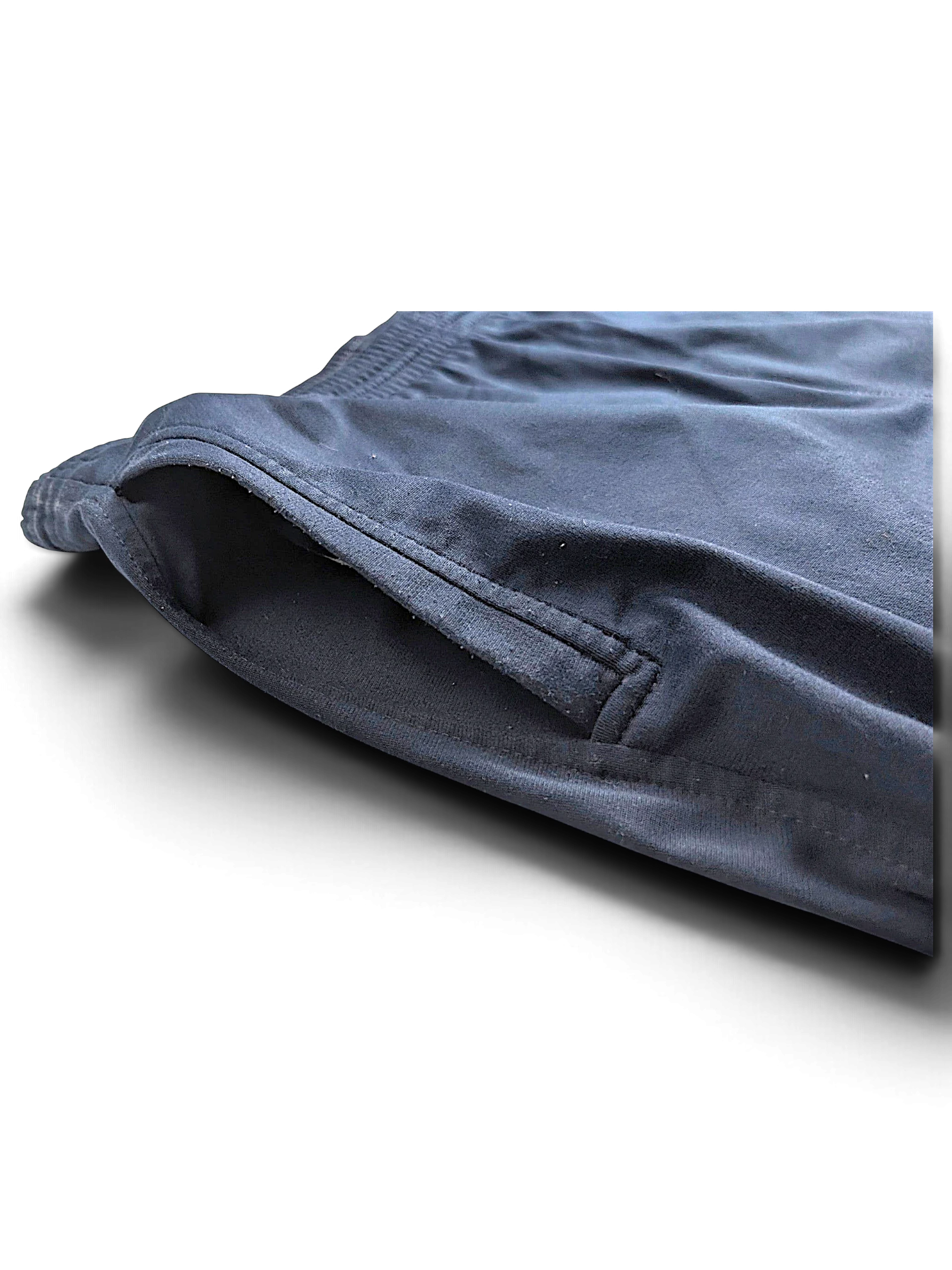 Close-up of the side pocket on JAKE & IPI pre-owned Champion navy blue open-hem track pants