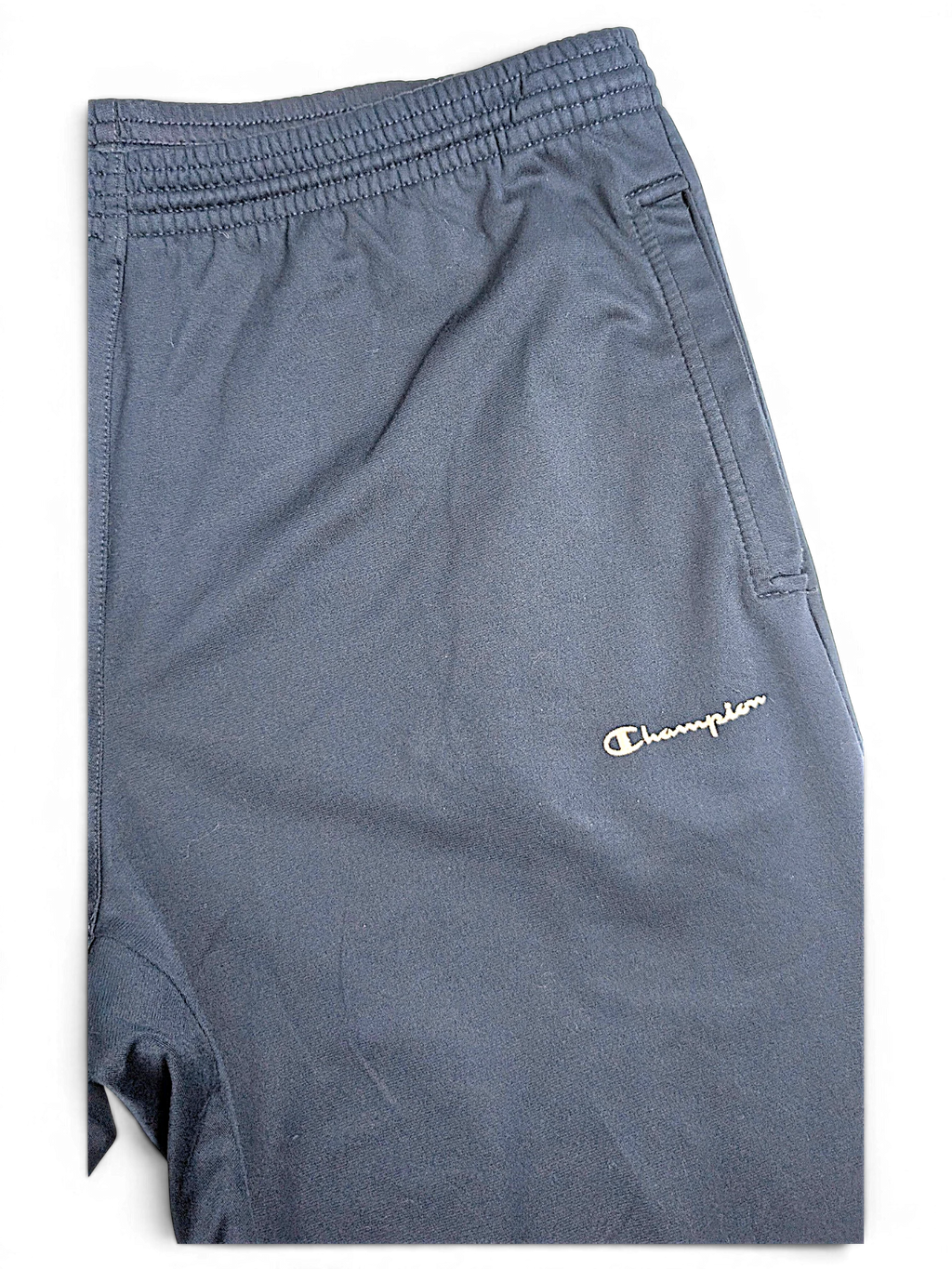 JAKE & IPI pre-owned Champion navy blue track pants with an elastic waistband and embroidered logo detail.