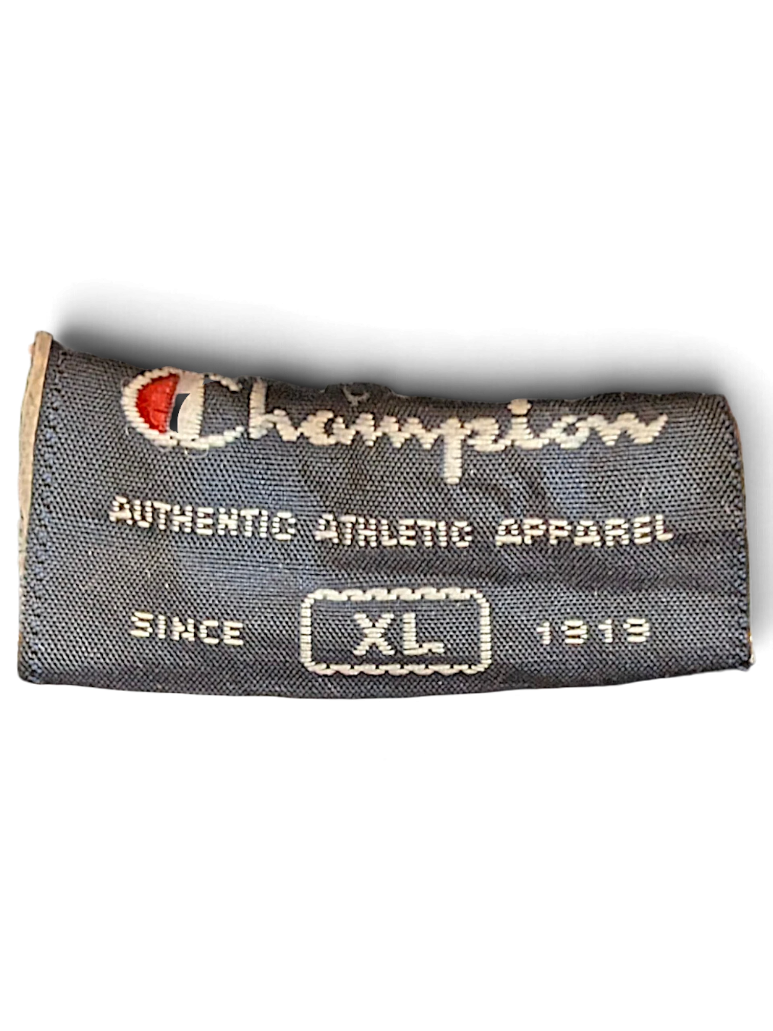 JAKE & IPI Champion brand clothing label in navy blue with white text and size XL indicator