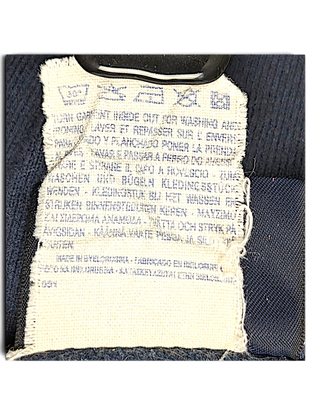 JAKE & IPI Champion track pants care label with washing instructions and manufacturing details