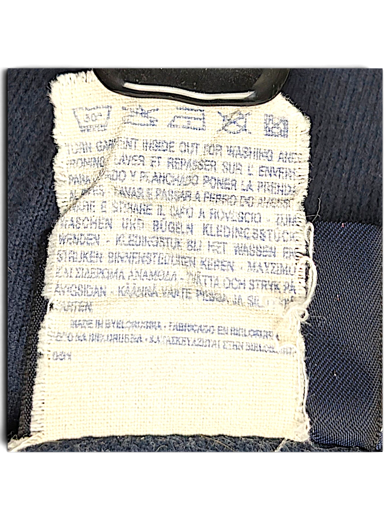 JAKE & IPI Champion track pants care label with washing instructions and manufacturing details