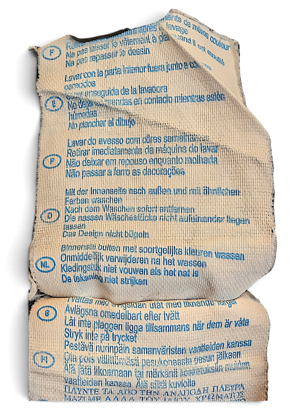 JAKE & IPI Champion track pants care label with multi-language washing instructions printed in blue on beige fabric.