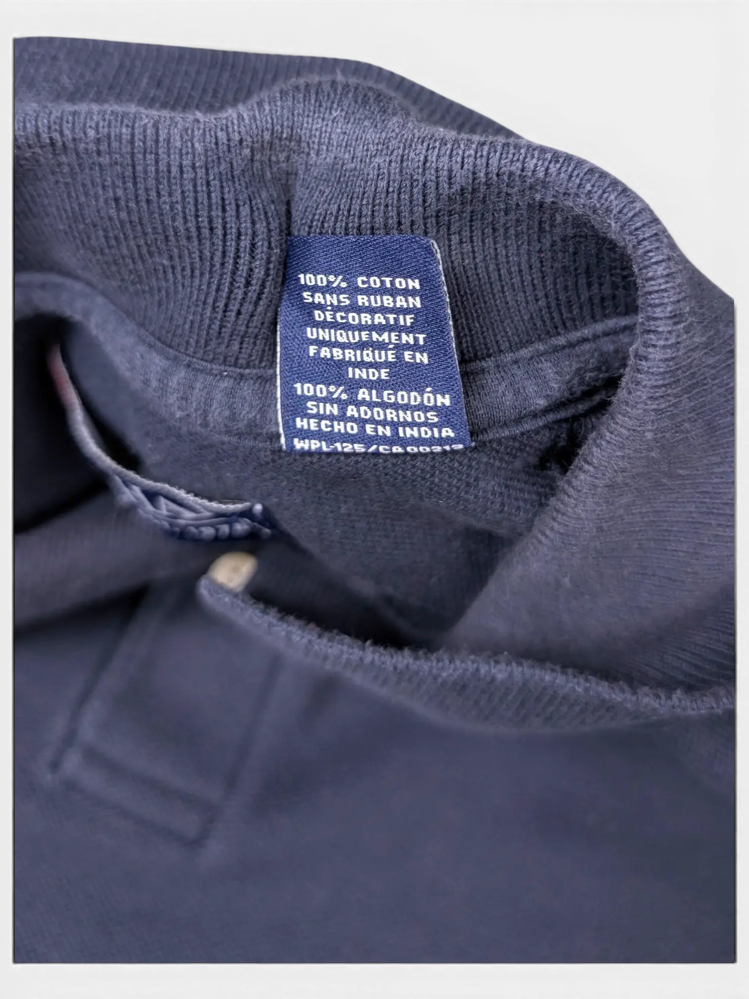 JAKE & IPI pre-owned Chaps navy cotton polo shirt interior care label showing 100 percent cotton fabric composition