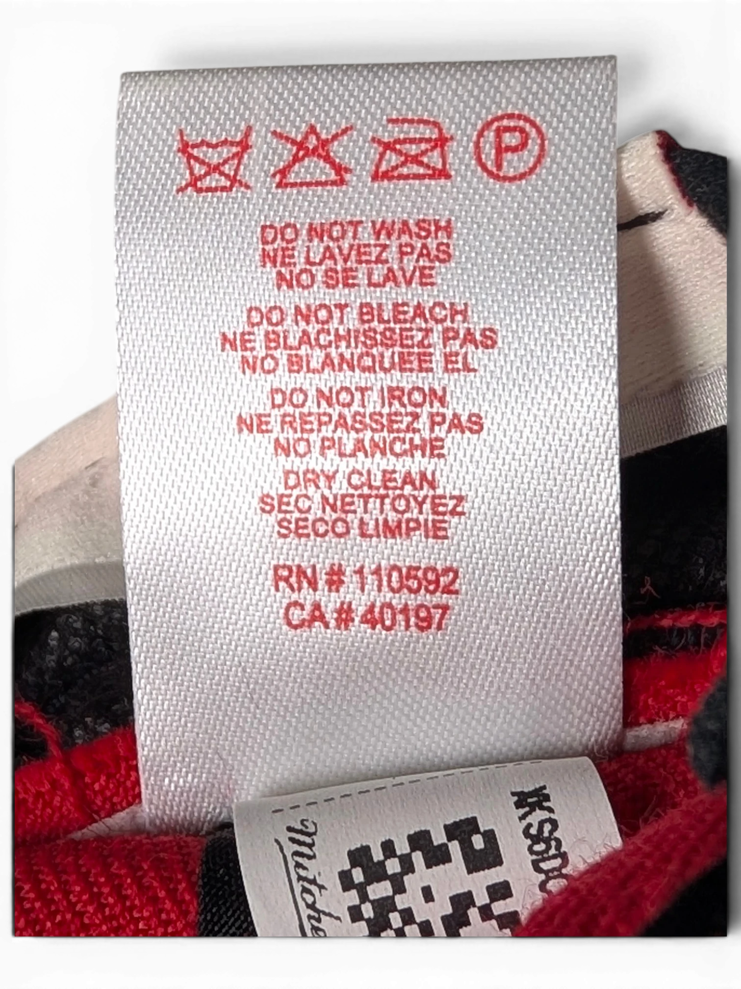 JAKE & IPI Chicago Bulls cap interior care label with red text and washing instructions on a white fabric tag