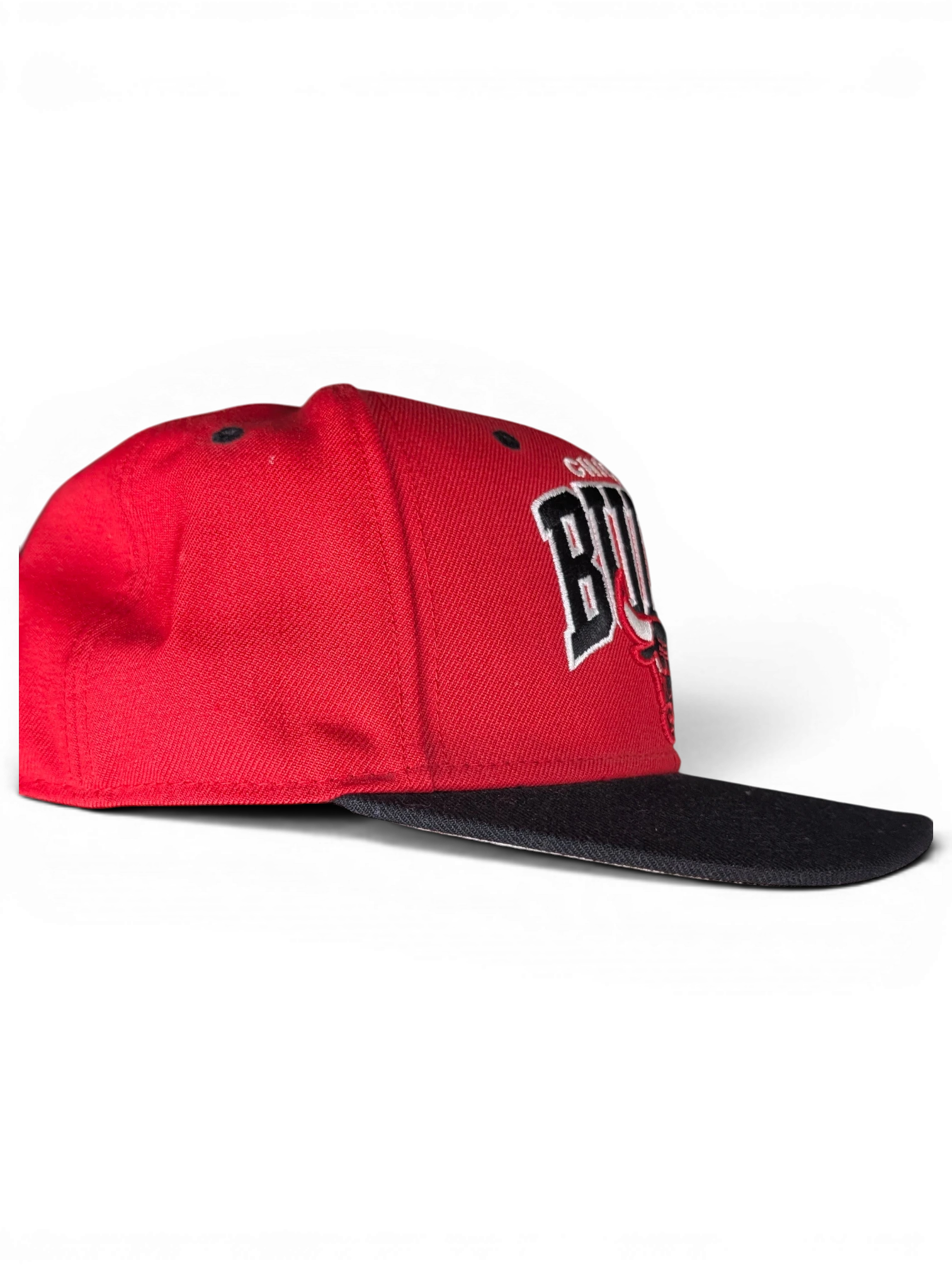 JAKE & IPI red and black Chicago Bulls snapback cap with embroidered team logo, side profile view