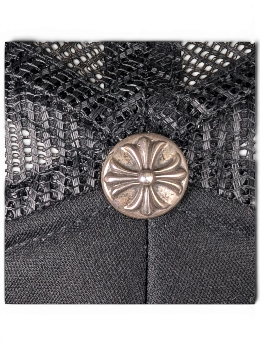 JAKE & IPI black trucker hat featuring a silver Chrome Hearts cross button detail on the mesh crown