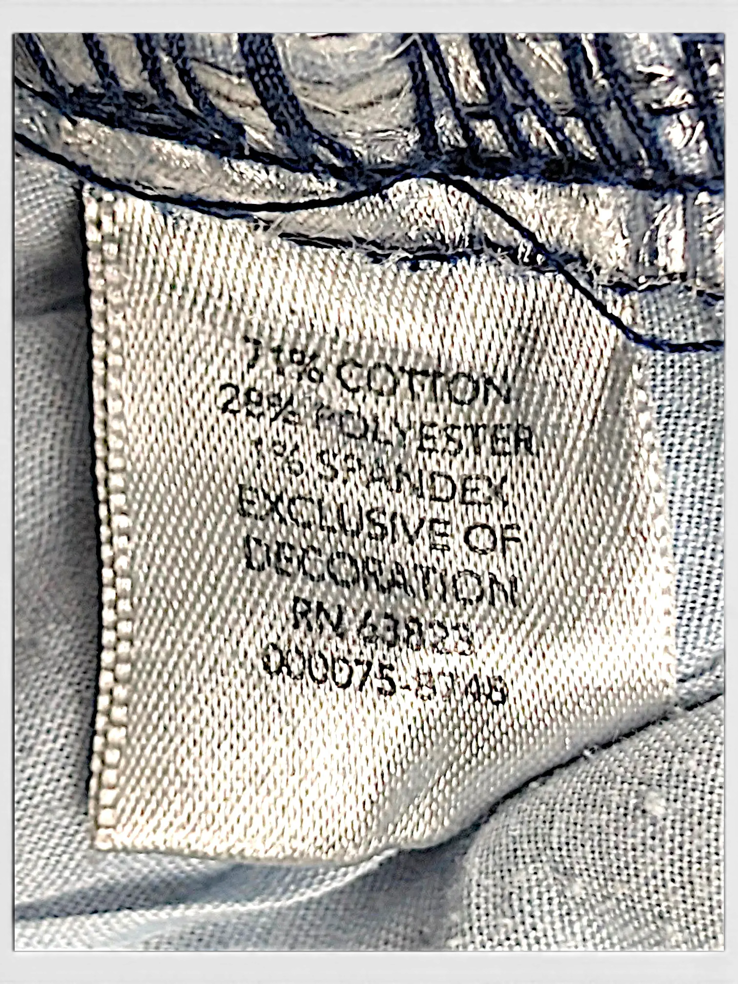 JAKE & IPI CJ Banks jeans fabric care label showing 71 percent cotton, 28 percent polyester, and 1 percent spandex