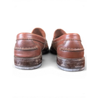 JAKE & IPI Clarks brown leather penny loafers, back view showing stitched heel detail and worn soles.