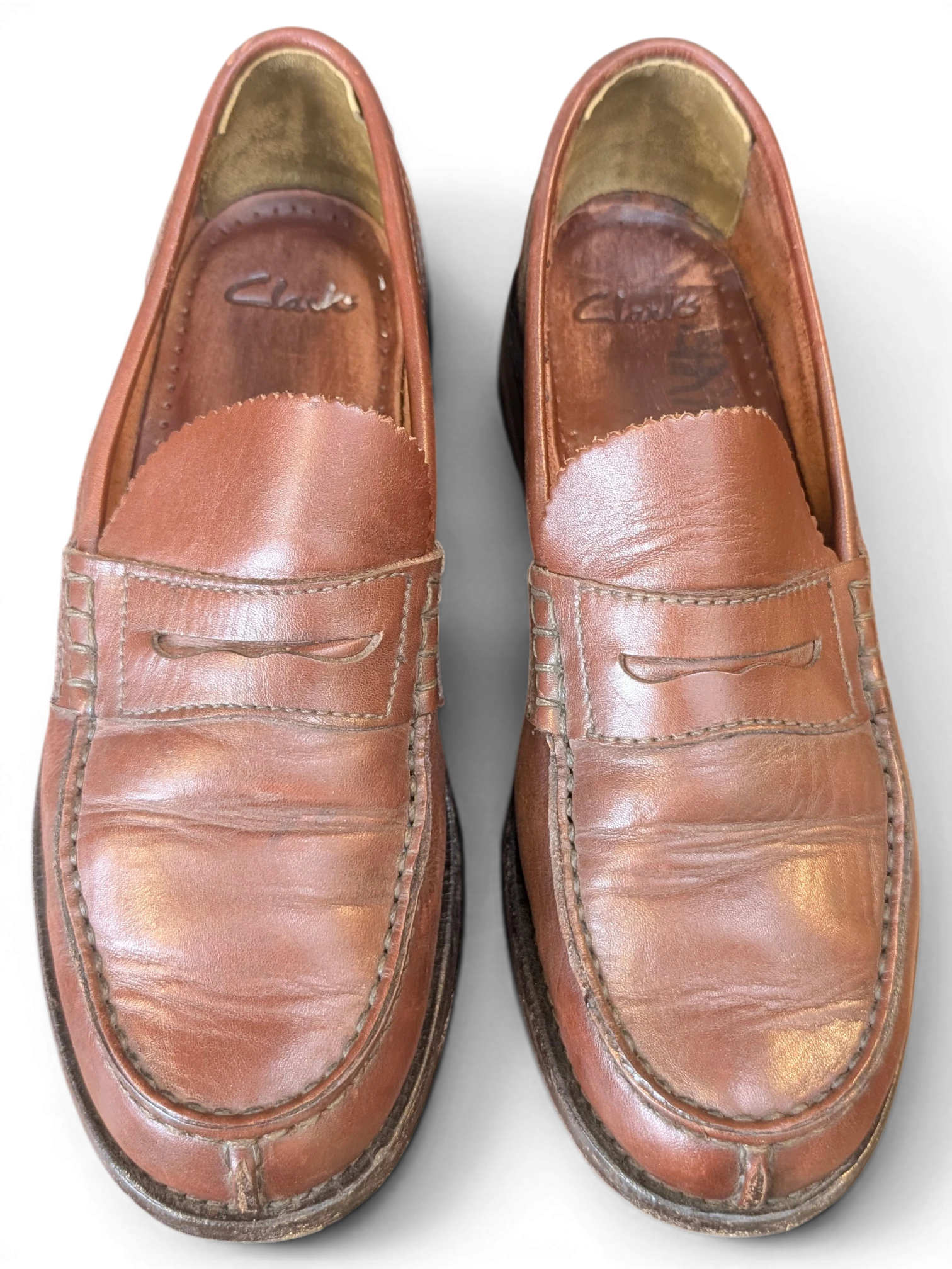 JAKE & IPI vintage Clarks brown leather penny loafers with classic slip-on design and worn-in patina