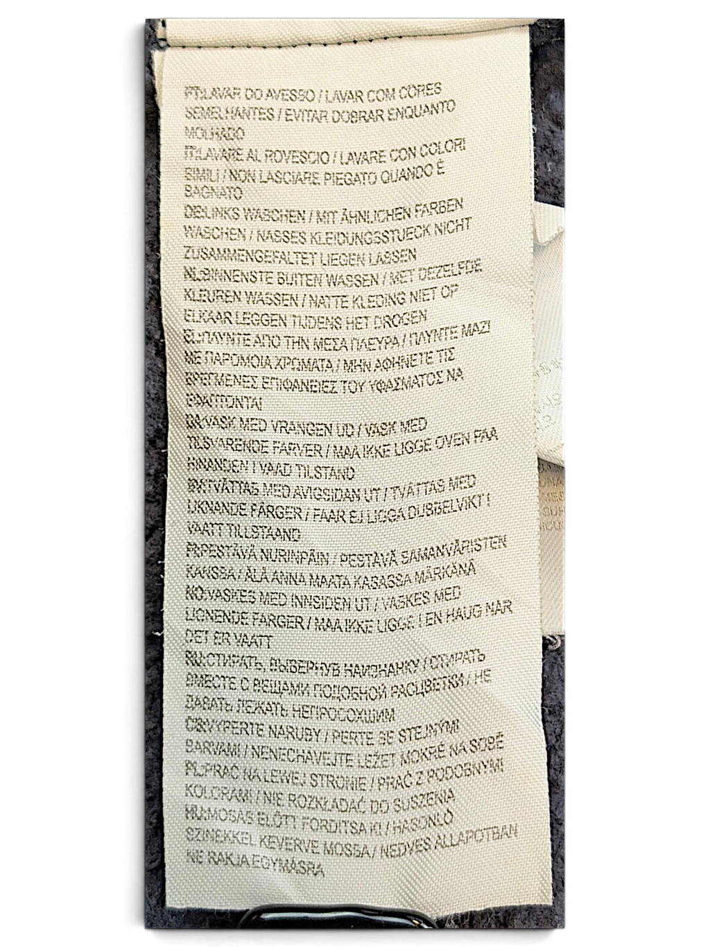 JAKE & IPI Converse Cropped College garment care label with multi-language washing instructions on navy fabric