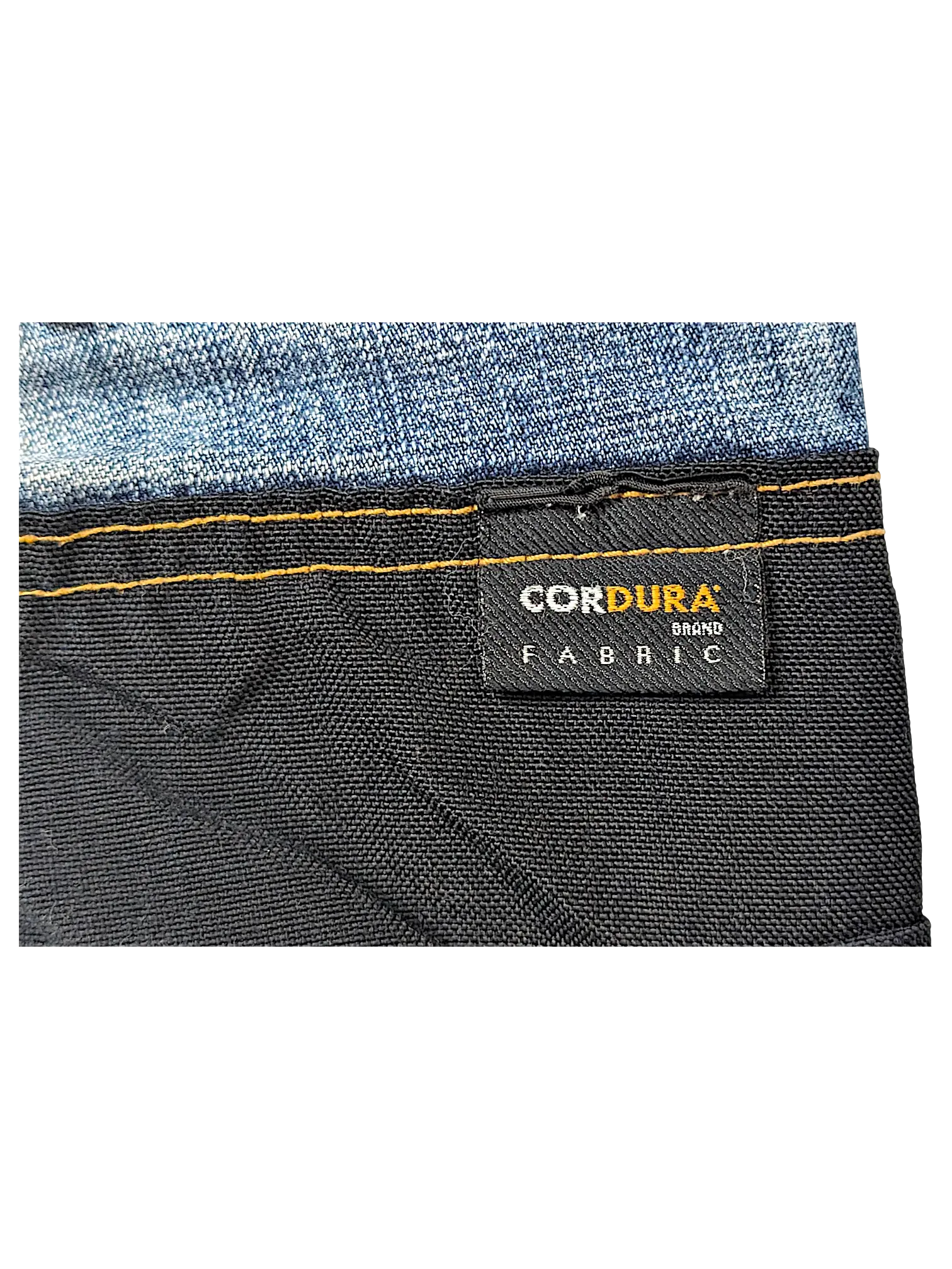 JAKE & IPI jeans featuring a black Cordura brand fabric panel with contrast orange stitching against blue denim
