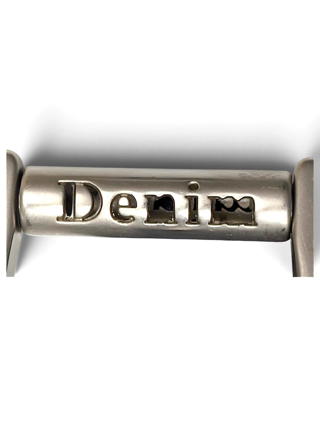 JAKE & IPI silver metal hardware detail featuring the word Denim engraved on a cylindrical bar