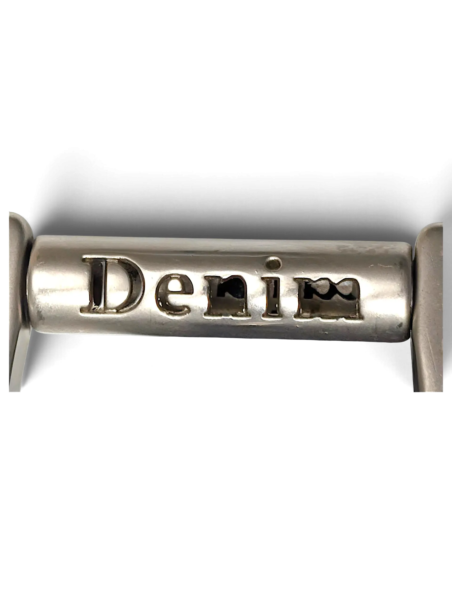 JAKE & IPI silver metal hardware detail featuring the word Denim engraved on a cylindrical bar