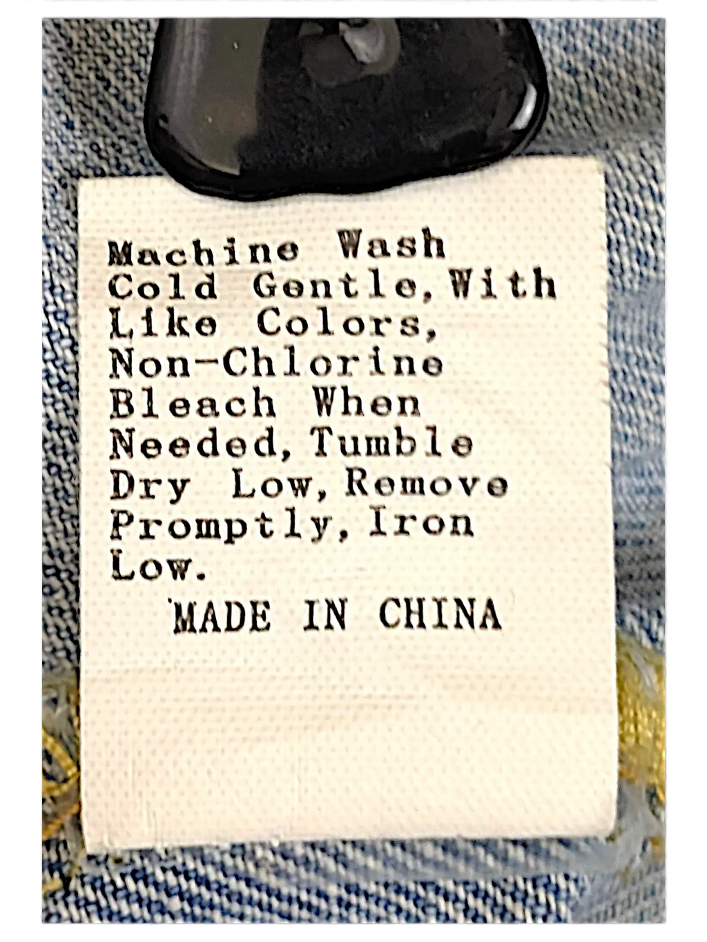 JAKE & IPI distressed denim jacket care label with washing instructions and made in China text