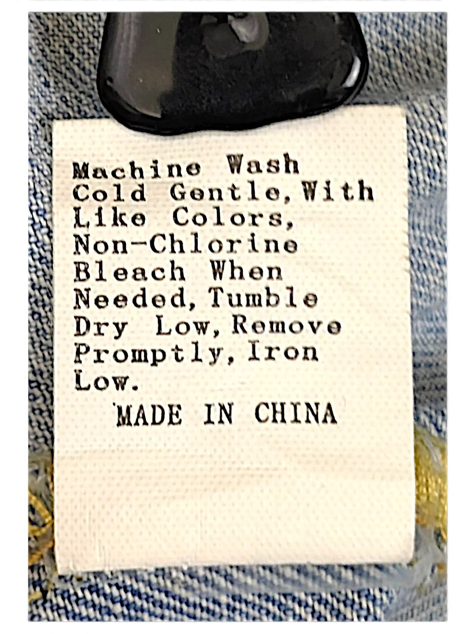 JAKE & IPI distressed denim jacket care label with washing instructions and made in China text