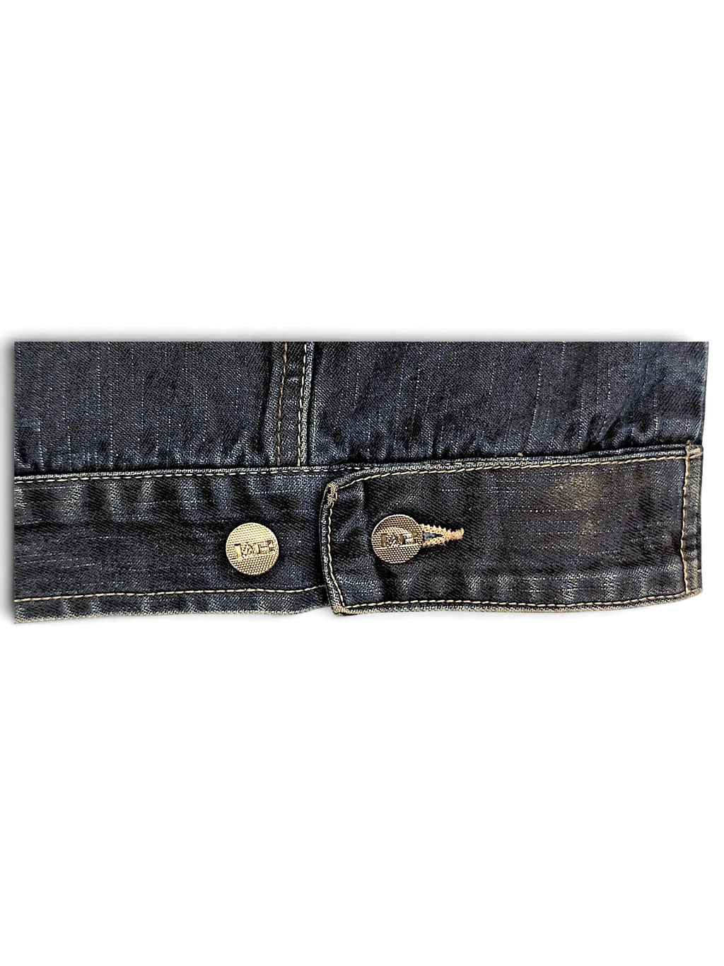Close-up of the dark blue denim hem and metallic buttons on a JAKE & IPI Johnny Blaze denim jacket
