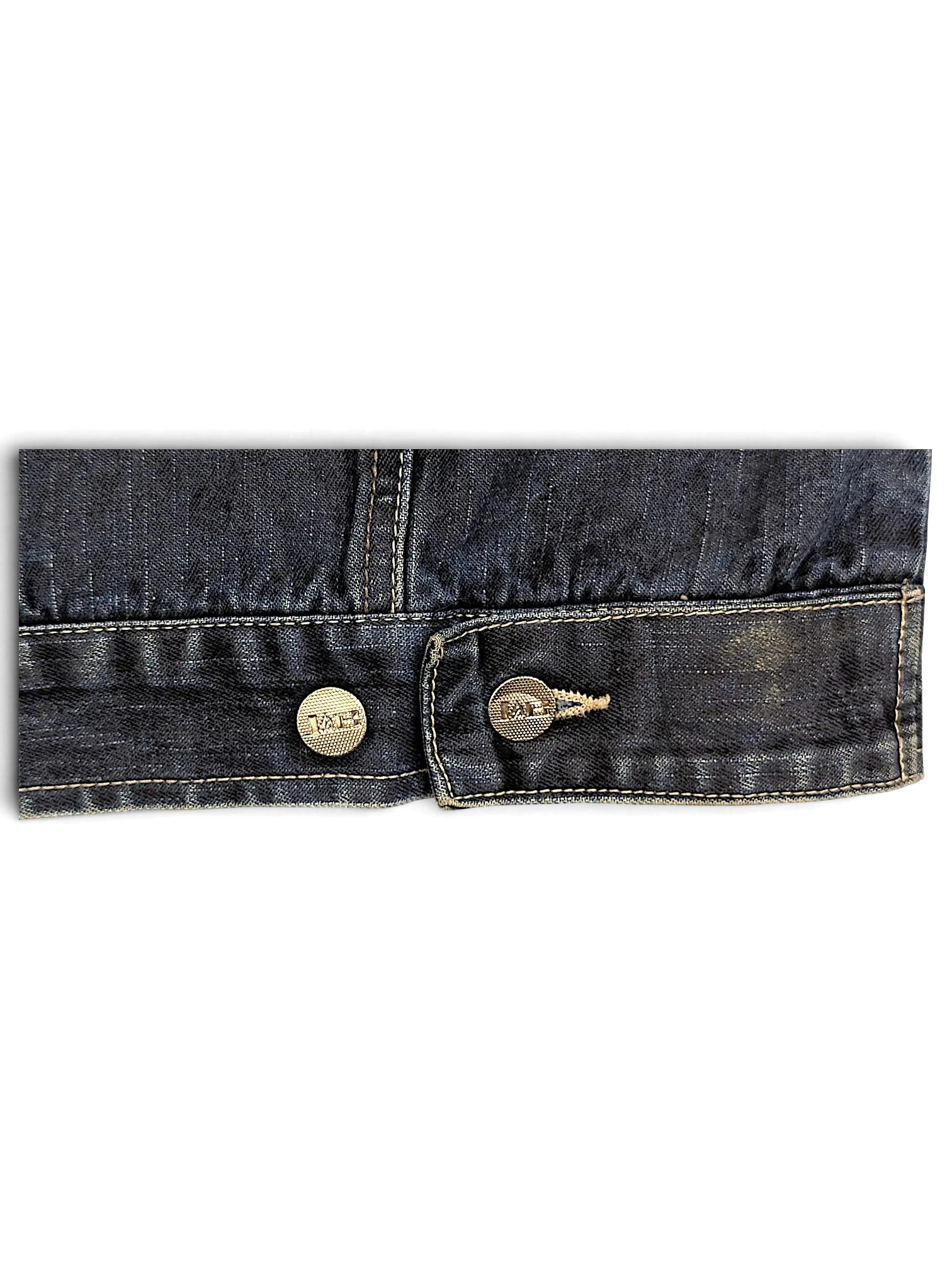 Close-up of the dark blue denim hem and metallic buttons on a JAKE & IPI Johnny Blaze denim jacket