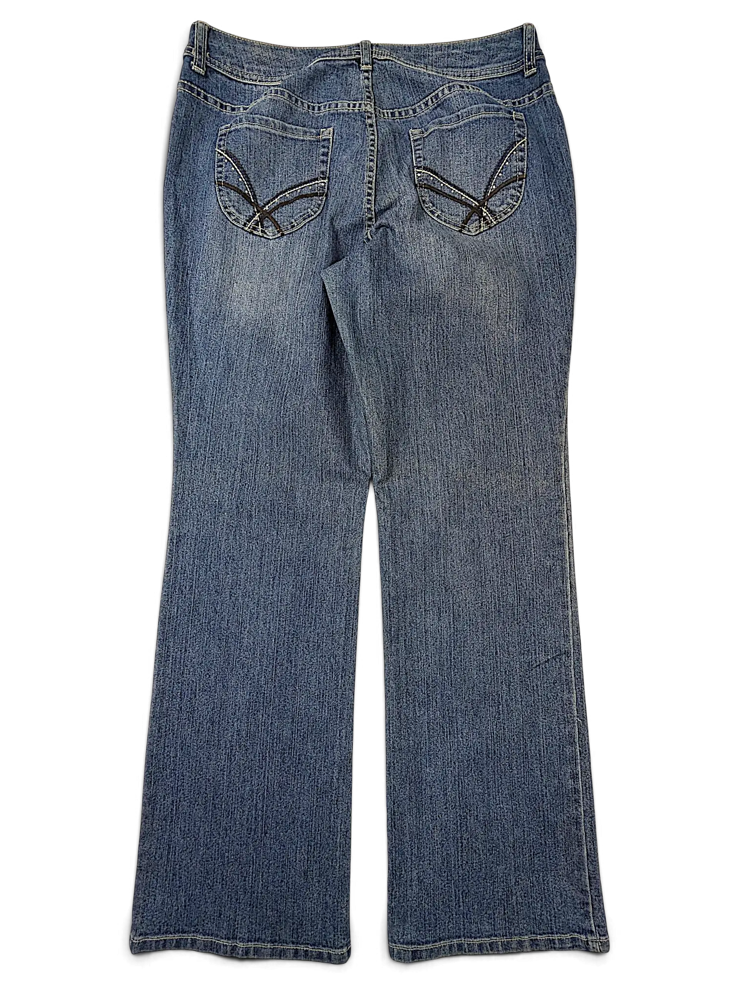 Back view of JAKE & IPI Additions by Chico's blue denim shorts with decorative stitching on the back pockets.