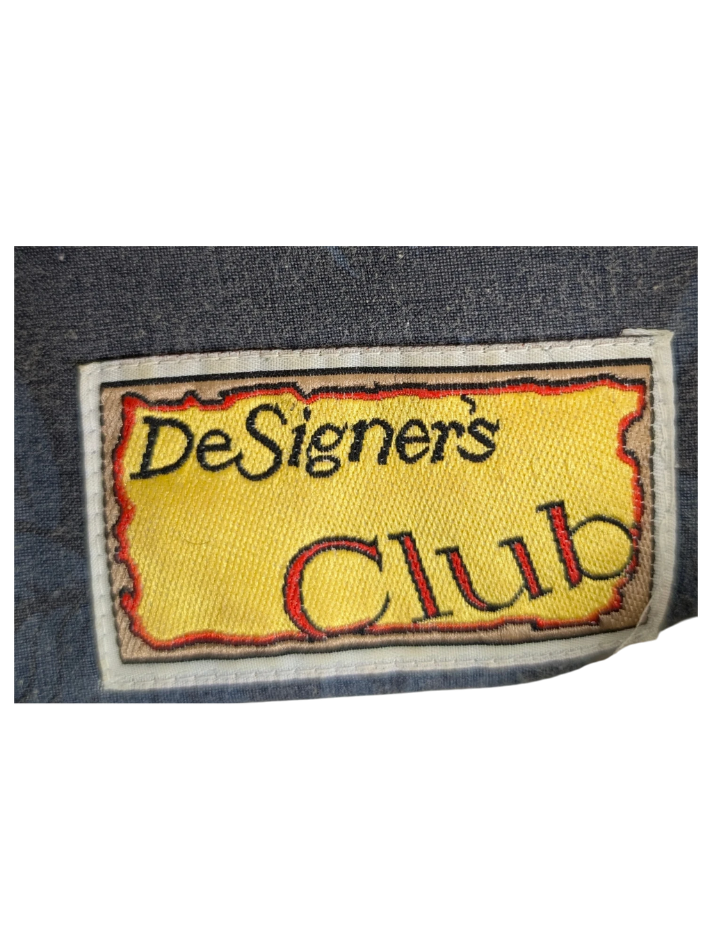JAKE & IPI vintage DeSigner's Club Hawaiian shirt label in size large on dark blue patterned fabric