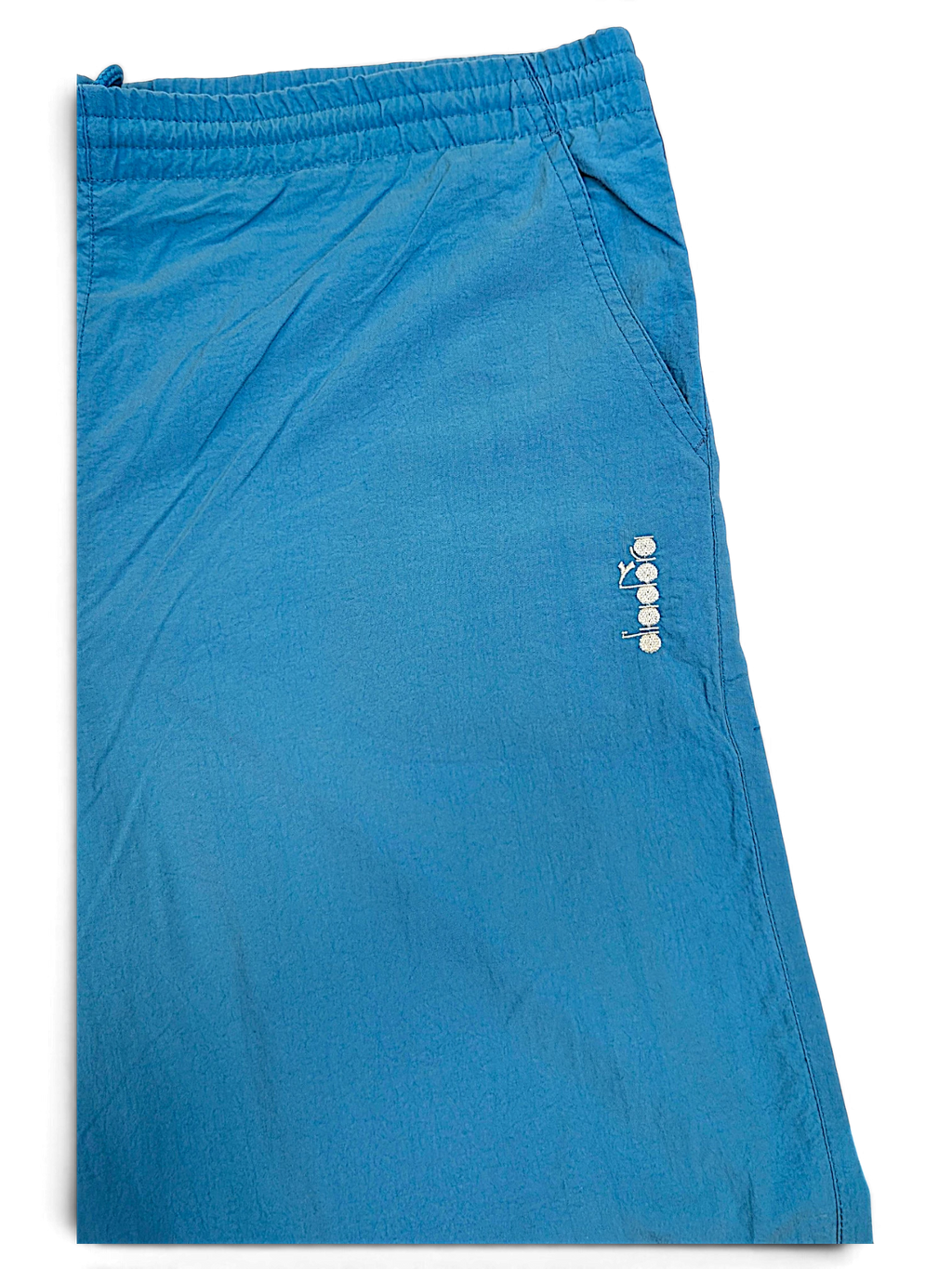 JAKE & IPI pre-owned Diadora track pants in faded light blue with an embroidered logo and relaxed fit