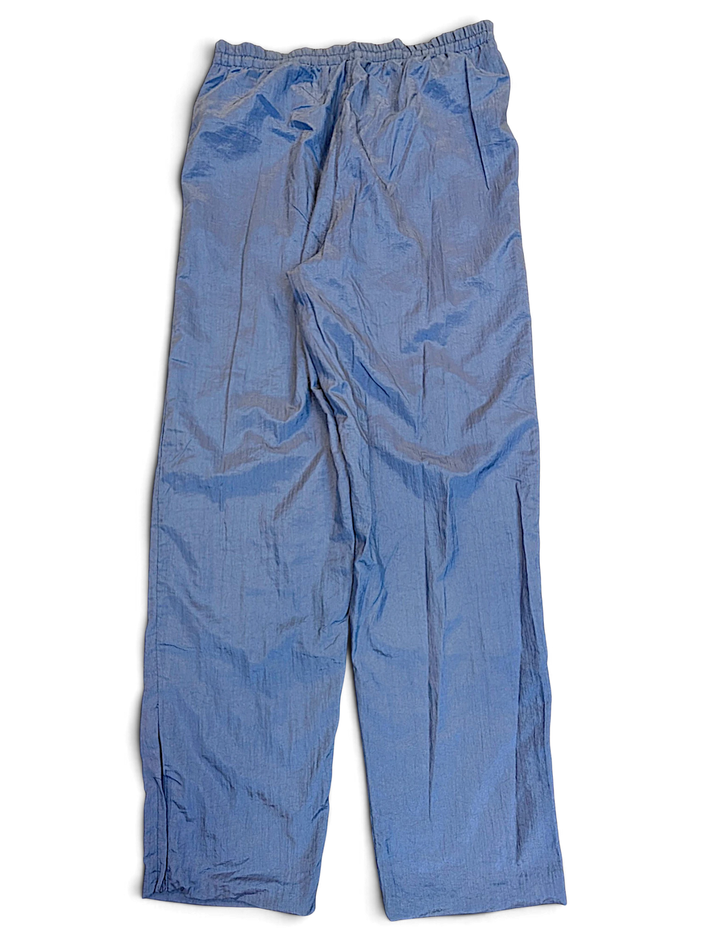 JAKE & IPI pre-owned Diadora light blue track pants with a shiny finish and relaxed leg fit.