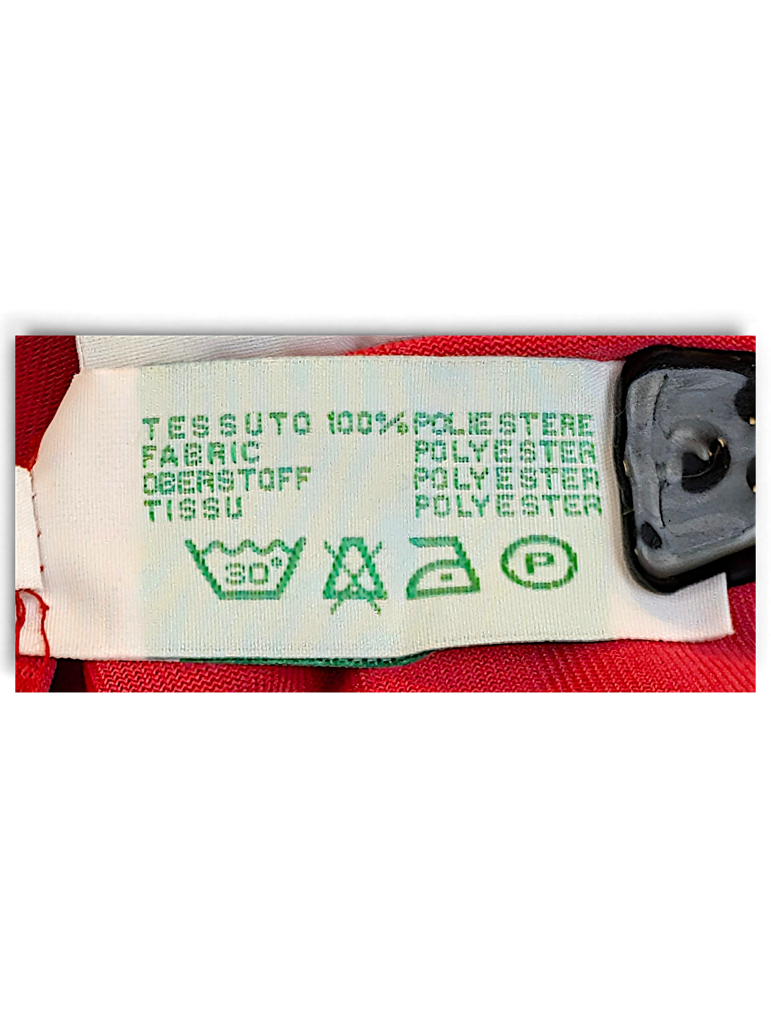 JAKE & IPI Diadora track pants care label showing 100 percent polyester composition and washing instructions