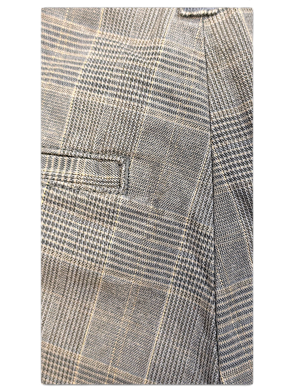 Close-up of JAKE & IPI Dickies grey plaid pleated trousers showing the textured fabric and pocket detail.