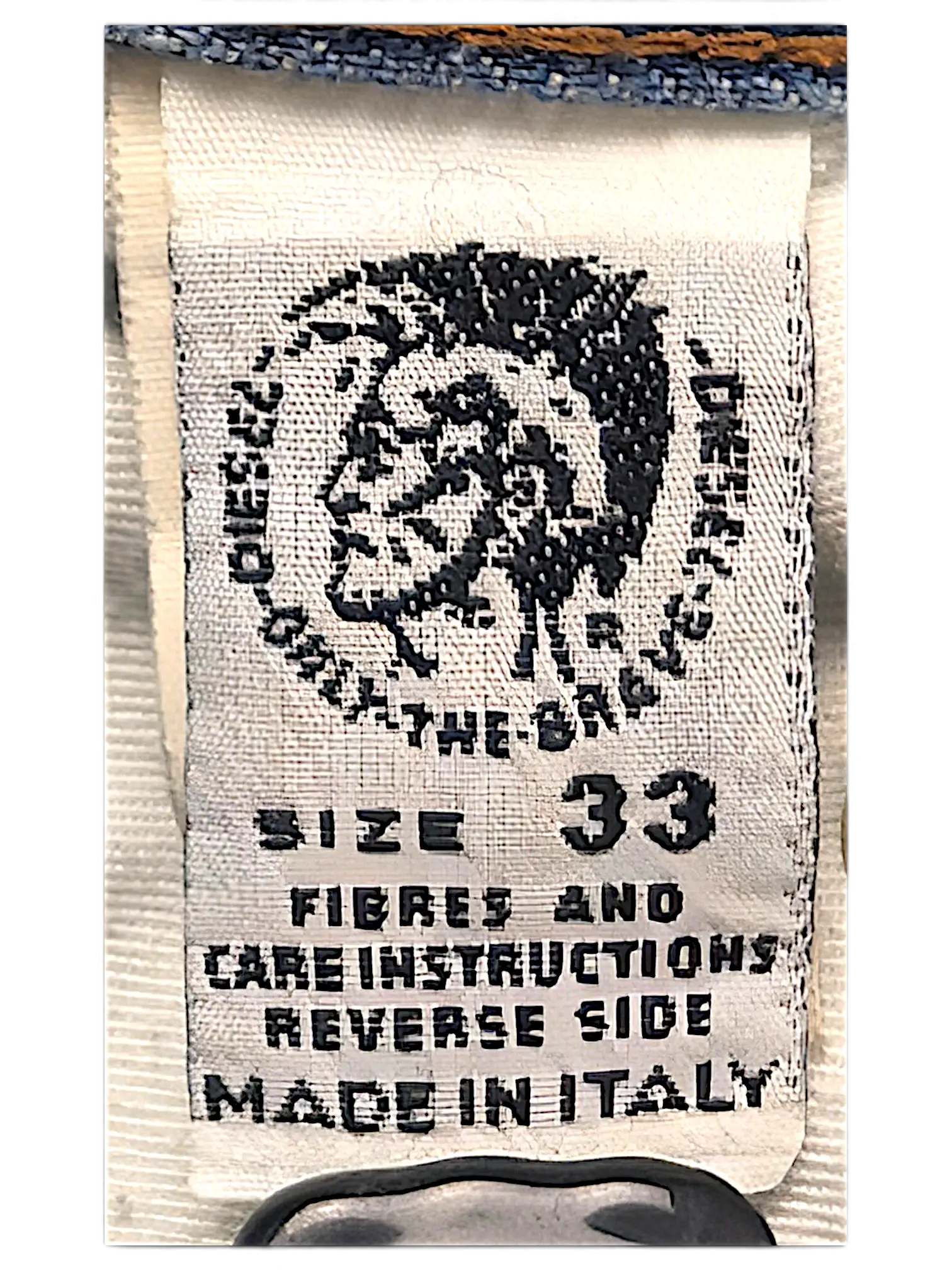JAKE & IPI Diesel jeans interior care label with size 33 and Made in Italy text on white fabric