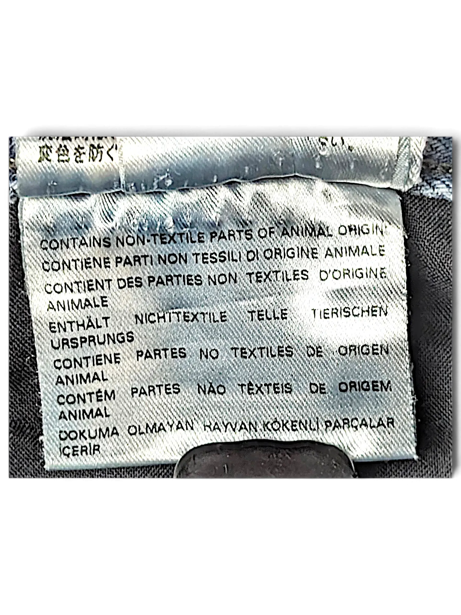 JAKE & IPI Diesel Krayer jeans care label showing non-textile animal origin parts warning in multiple languages.