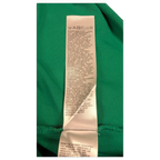 JAKE & IPI green Diesel polo shirt care instruction label with washing symbols and text in multiple languages.