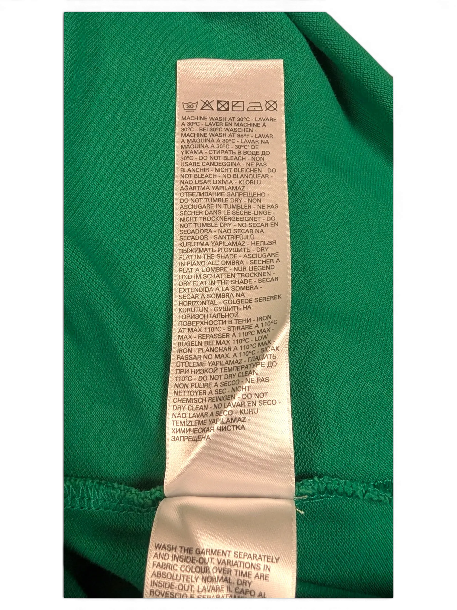 JAKE & IPI green Diesel polo shirt care instruction label with washing symbols and text in multiple languages.