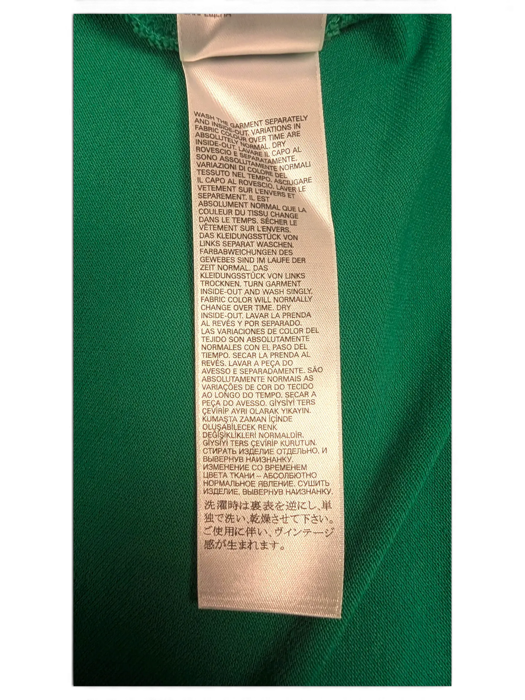 JAKE & IPI Diesel green polo shirt care instruction label with multi-language washing information