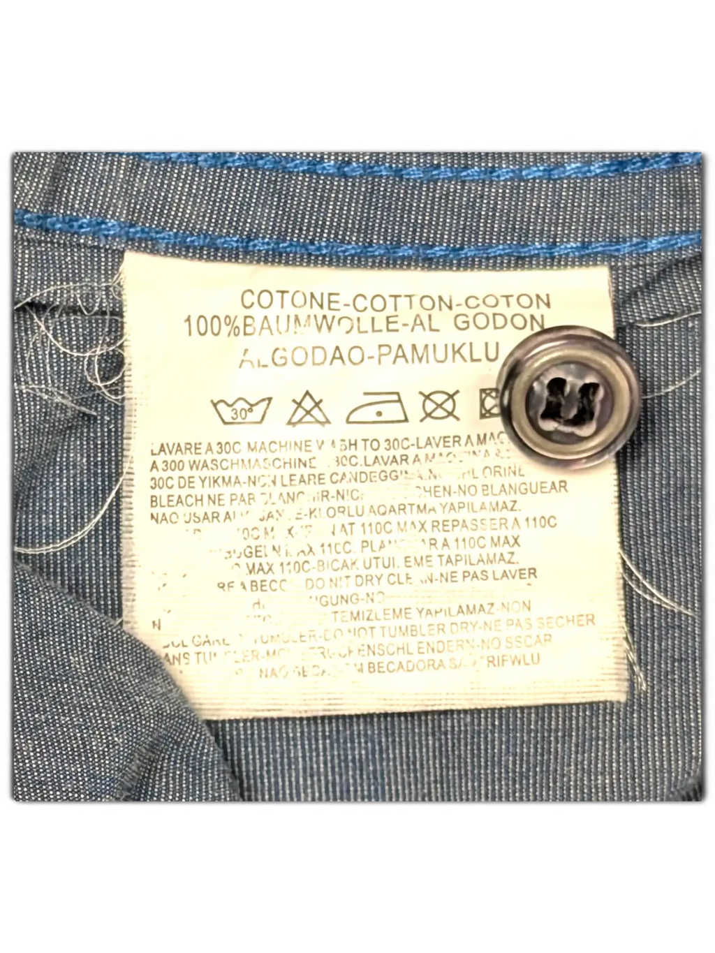 JAKE & IPI Diesel charcoal grey shirt care label showing 100% cotton material composition and washing instructions.