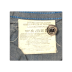 JAKE & IPI Diesel charcoal grey shirt care label showing 100% cotton material composition and washing instructions.