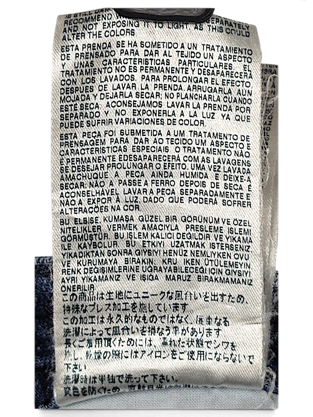 JAKE & IPI Diesel Thavar jeans care label with multi-language washing instructions on blue denim fabric