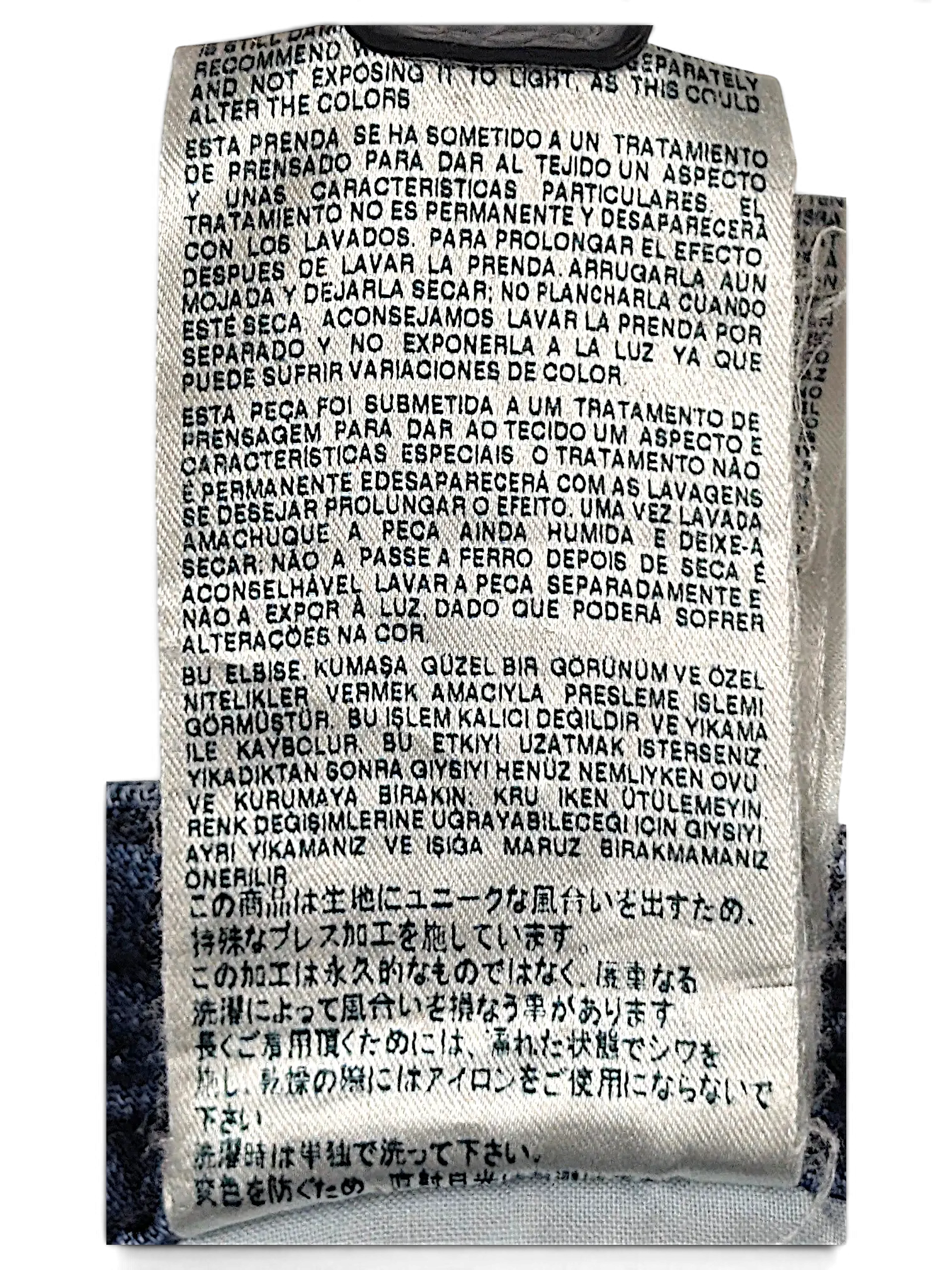 JAKE & IPI Diesel Thavar jeans care label with multi-language washing instructions on blue denim fabric