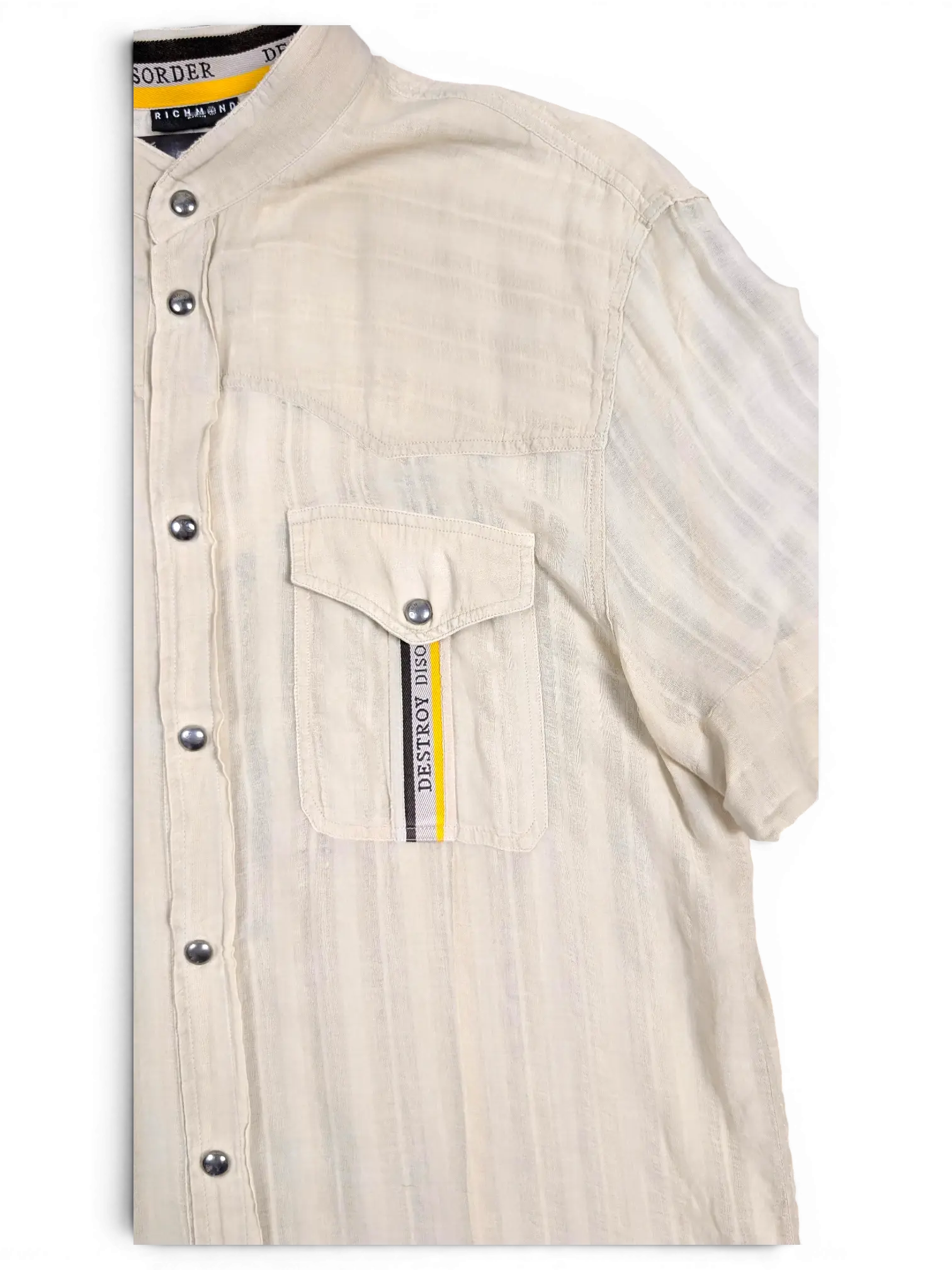 JAKE & IPI pre-owned beige Disorder utility shirt with stand collar, metal snap buttons, and chest pocket detail.